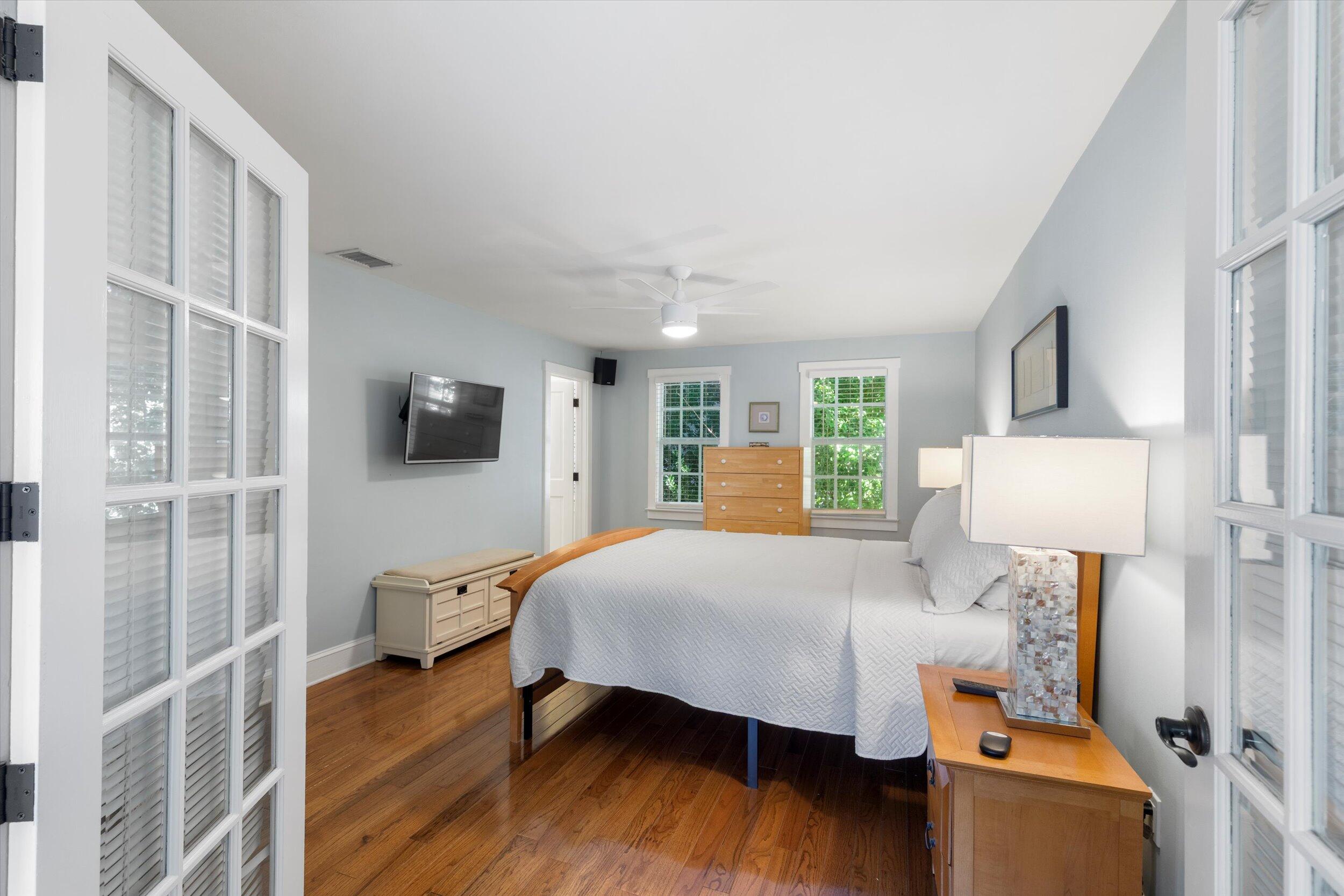 606 Truman Avenue, Unit 7 Key West, FL 33040 - Photo 31 of 49 a bedroom with a bed and wooden floor