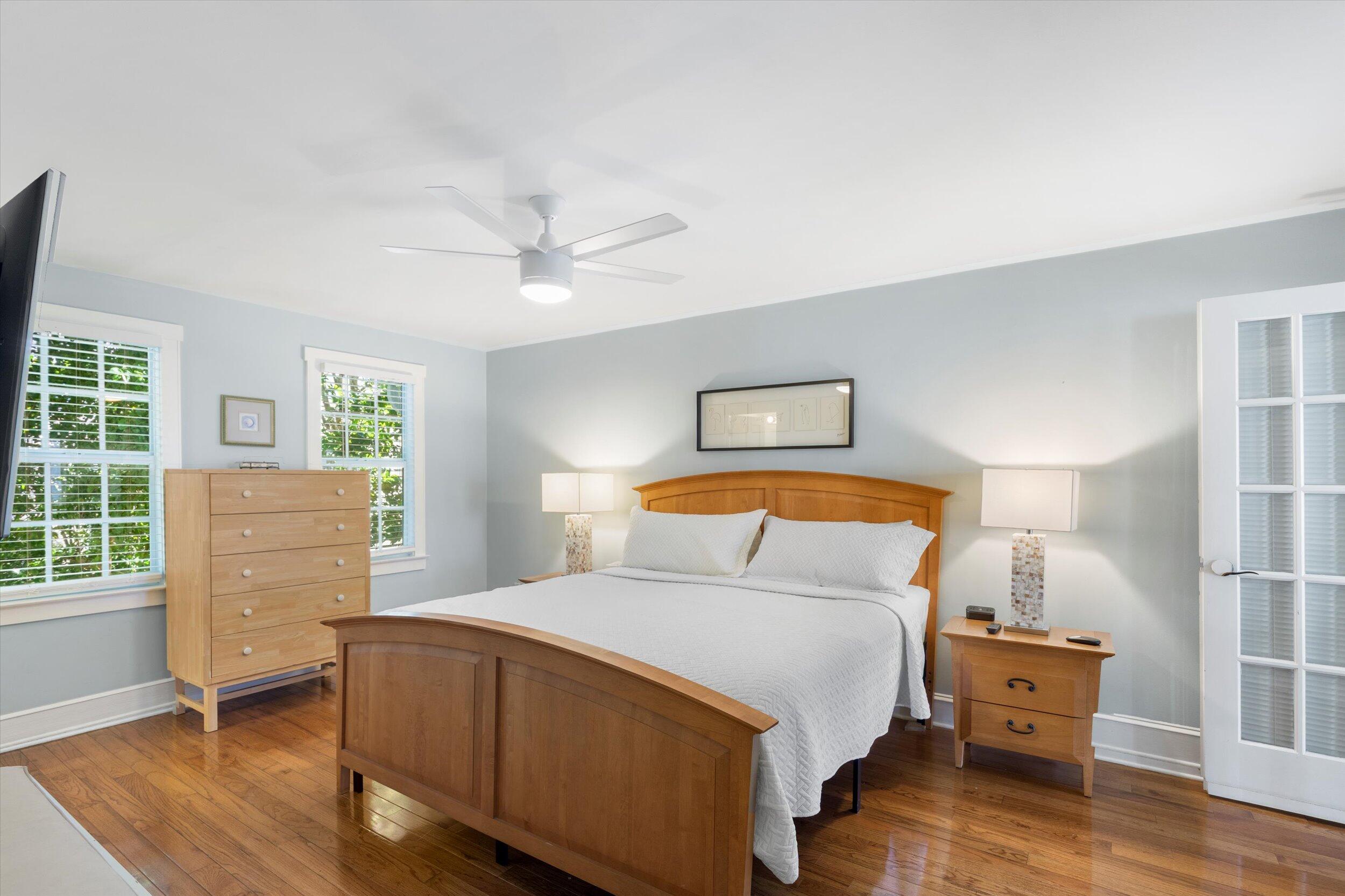 606 Truman Avenue, Unit 7 Key West, FL 33040 - Photo 33 of 49 a bedroom with a bed and wooden floor