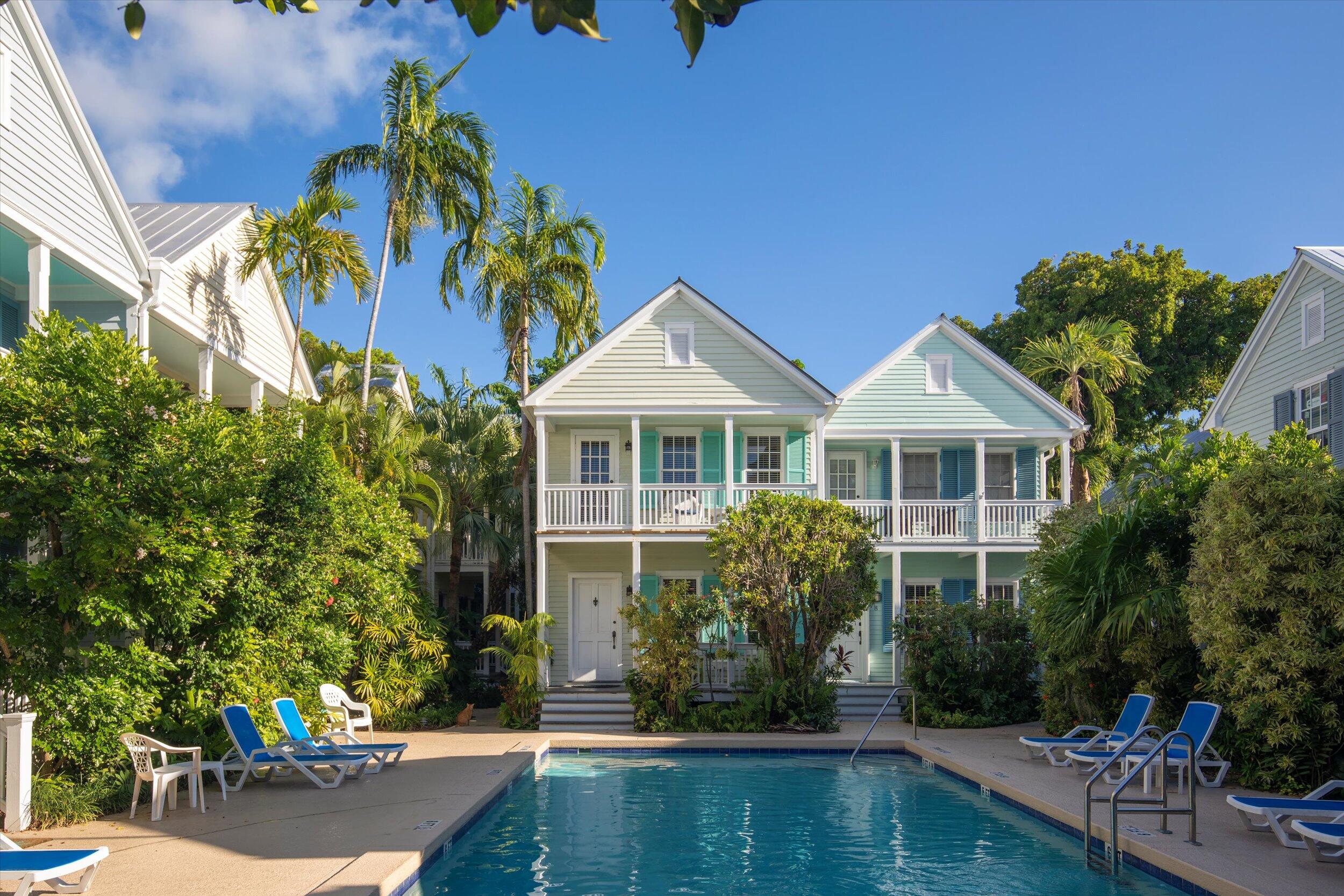 606 Truman Avenue, Unit 7 Key West, FL 33040 - Photo 42 of 49 a front view of house with yard and trees in the background