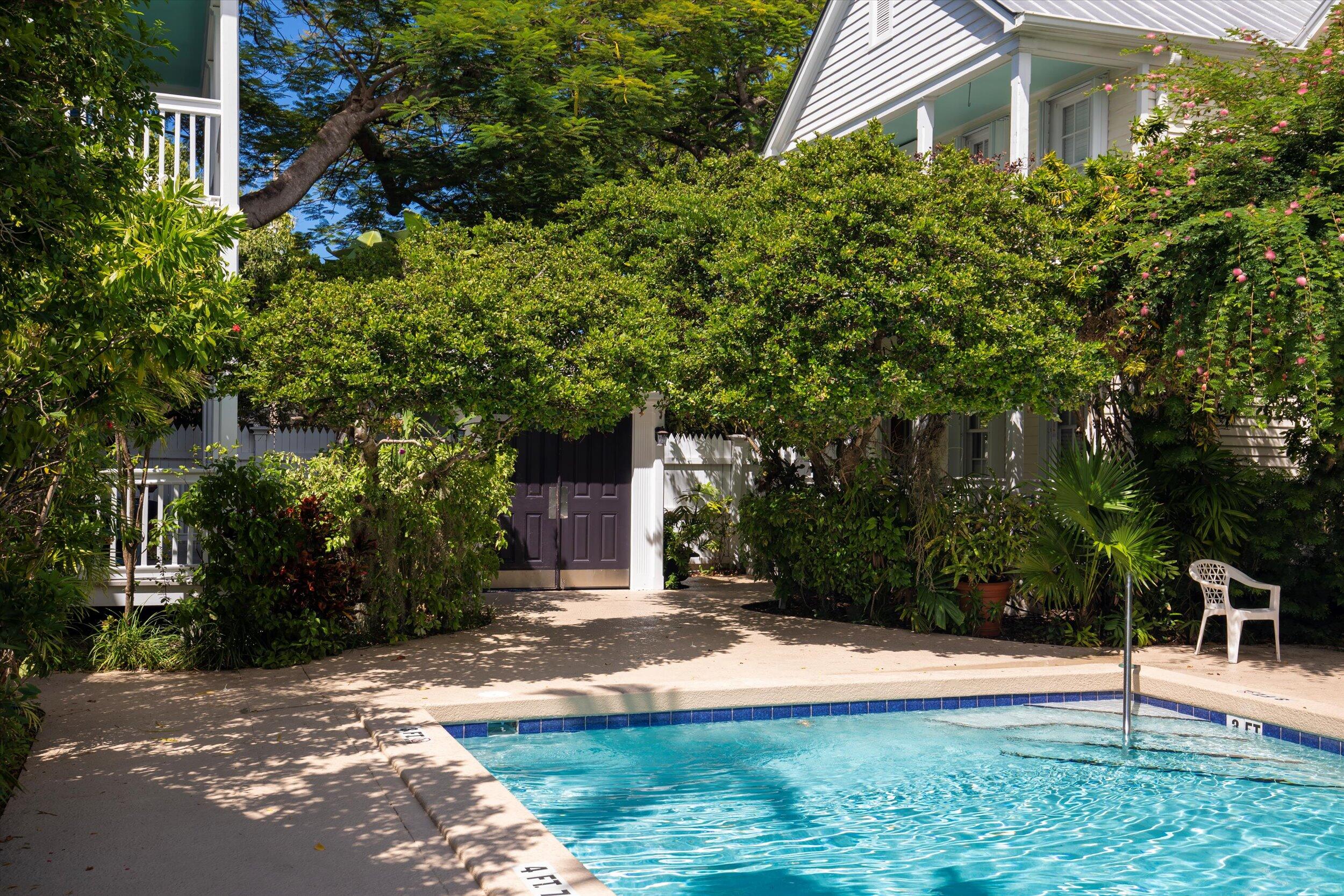 606 Truman Avenue, Unit 7 Key West, FL 33040 - Photo 48 of 49 a view of a yard with plants and large trees