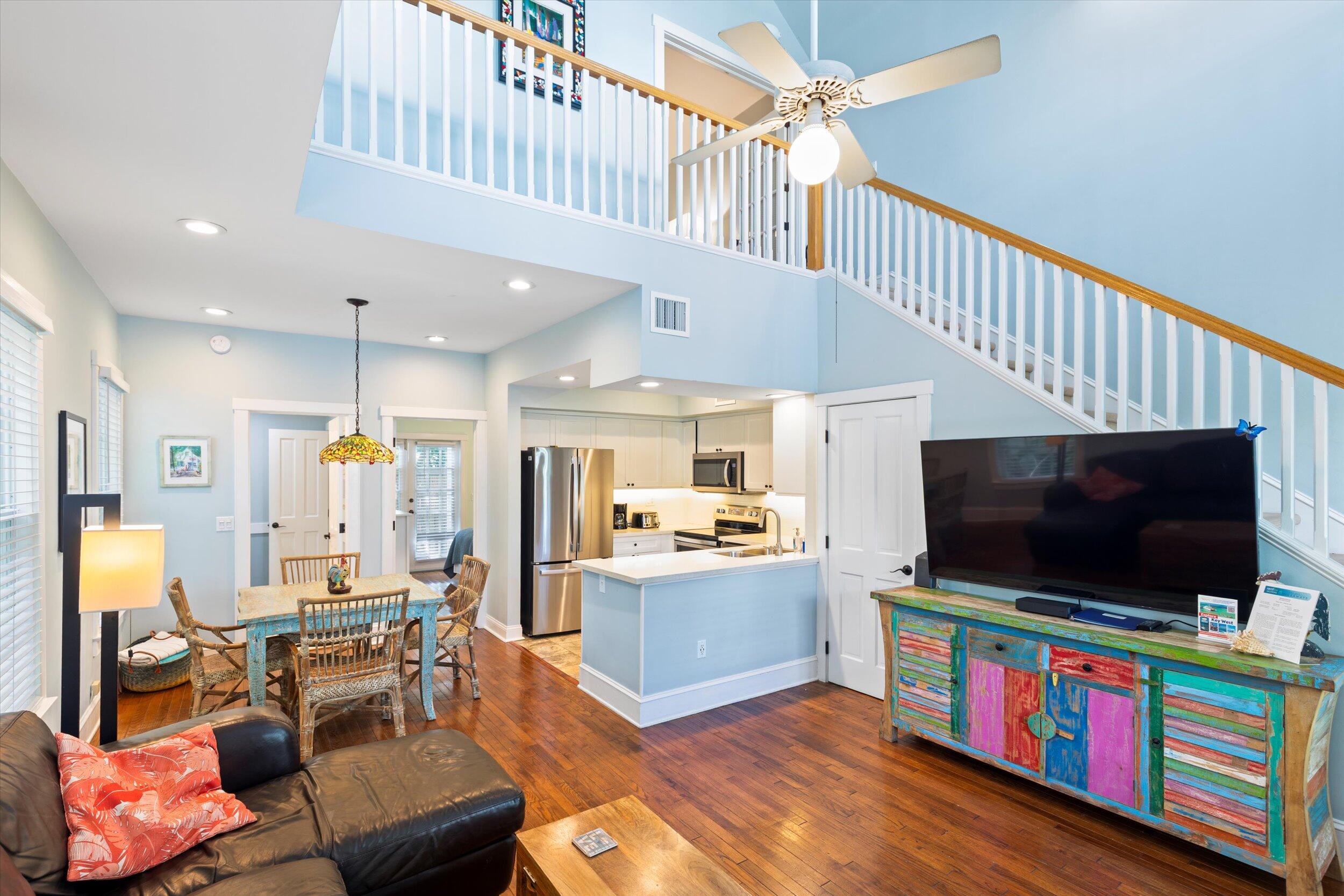 606 Truman Avenue, Unit 7 Key West, FL 33040 - Photo 7 of 49 a living room with furniture and a flat screen tv