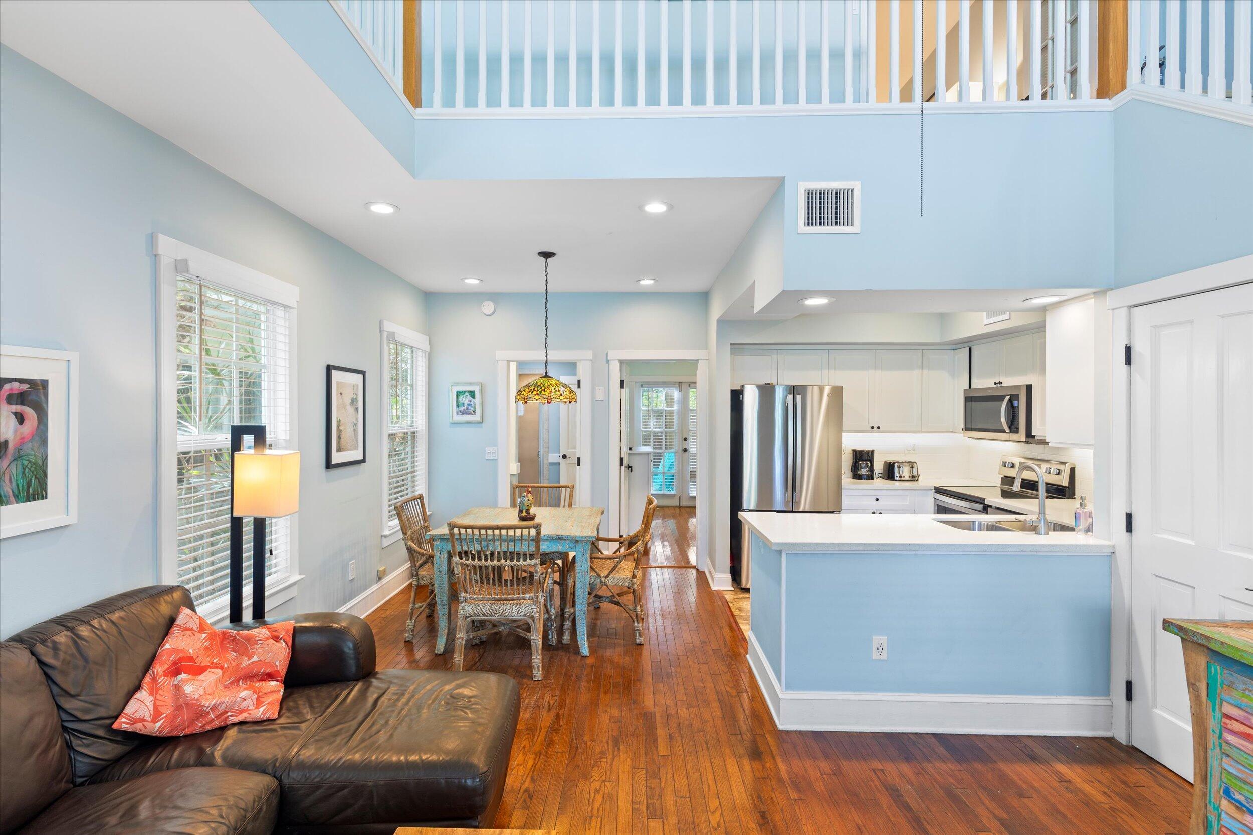 606 Truman Avenue, Unit 7 Key West, FL 33040 - Photo 8 of 49 a living room with furniture and kitchen view with wooden floor