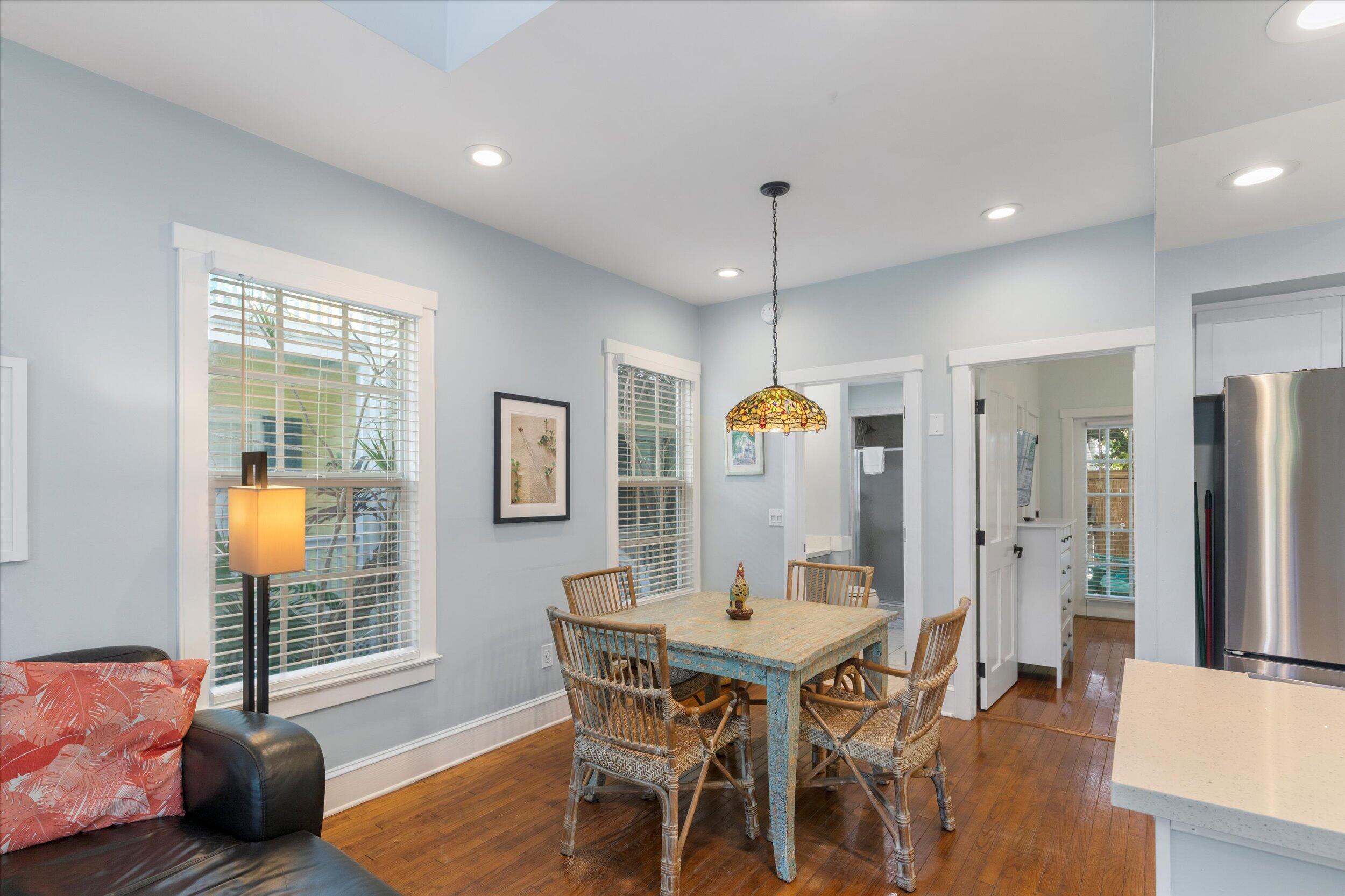 606 Truman Avenue, Unit 7 Key West, FL 33040 - Photo 9 of 49 a view of a dining room with furniture and wooden floor