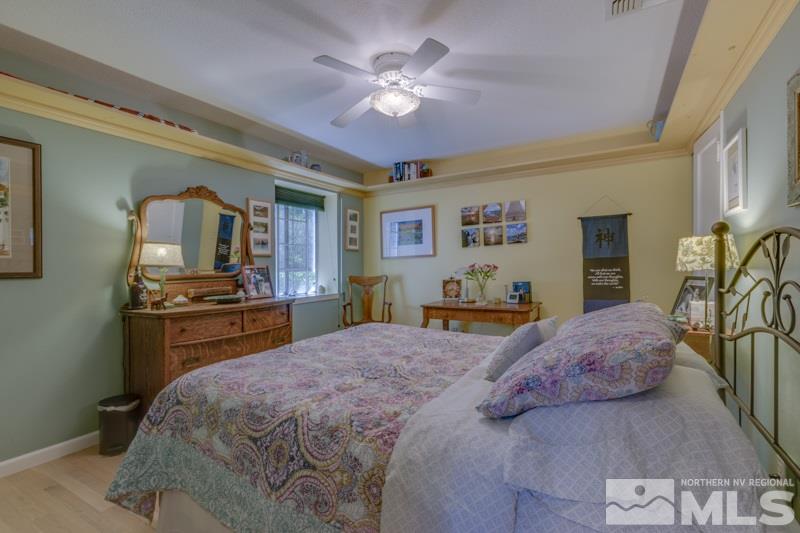 572 Ridge Street Reno, NV 89501 - Photo 17 of 25 a bedroom with a large bed and a chandelier