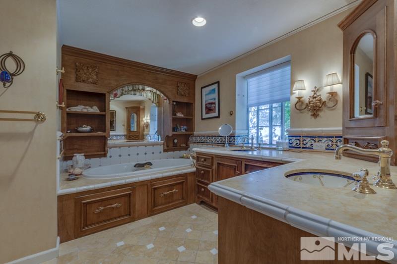 572 Ridge Street Reno, NV 89501 - Photo 20 of 25 a bathroom with a granite countertop sink a mirror and with
