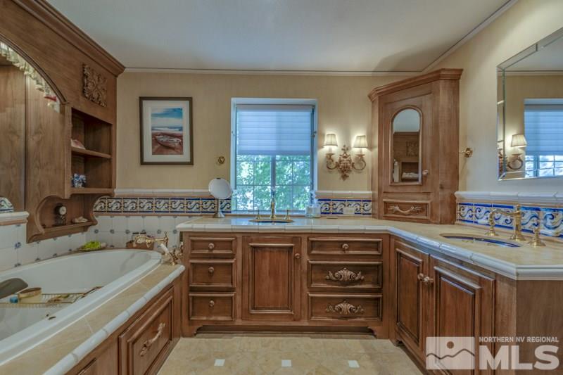 572 Ridge Street Reno, NV 89501 - Photo 21 of 25 a spacious bathroom with a granite countertop sink and a mirror