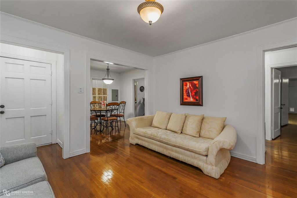 515 Davis Street Minden, LA 71055 - Photo 9 of 28 a living room with furniture and a dining table with wooden floor