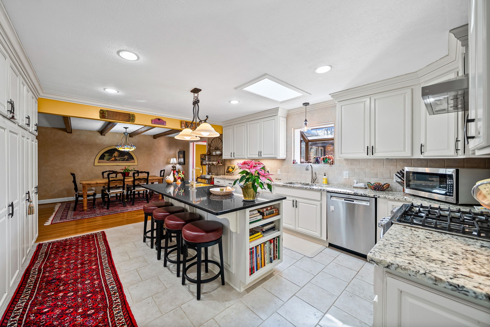 2419 Williams Hollow Road McEwen, TN 37101 - Photo 11 of 85 a kitchen with stainless steel appliances granite countertop a stove top oven a sink dishwasher and a dining table with wooden floor