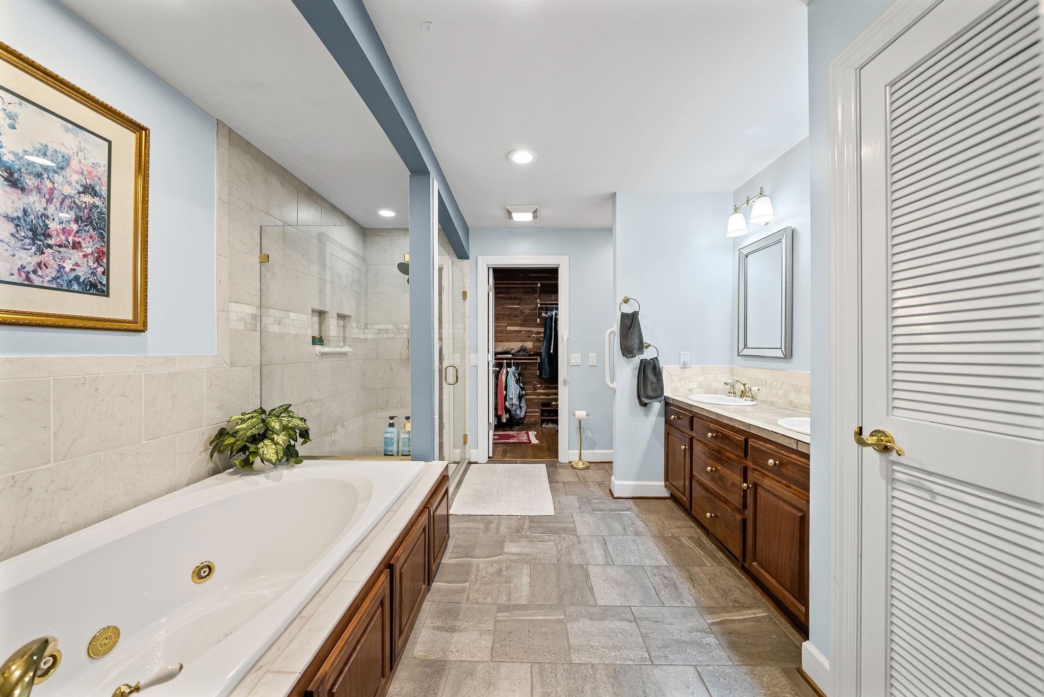2419 Williams Hollow Road McEwen, TN 37101 - Photo 22 of 85 a bathroom with a tub a sink and a large mirror