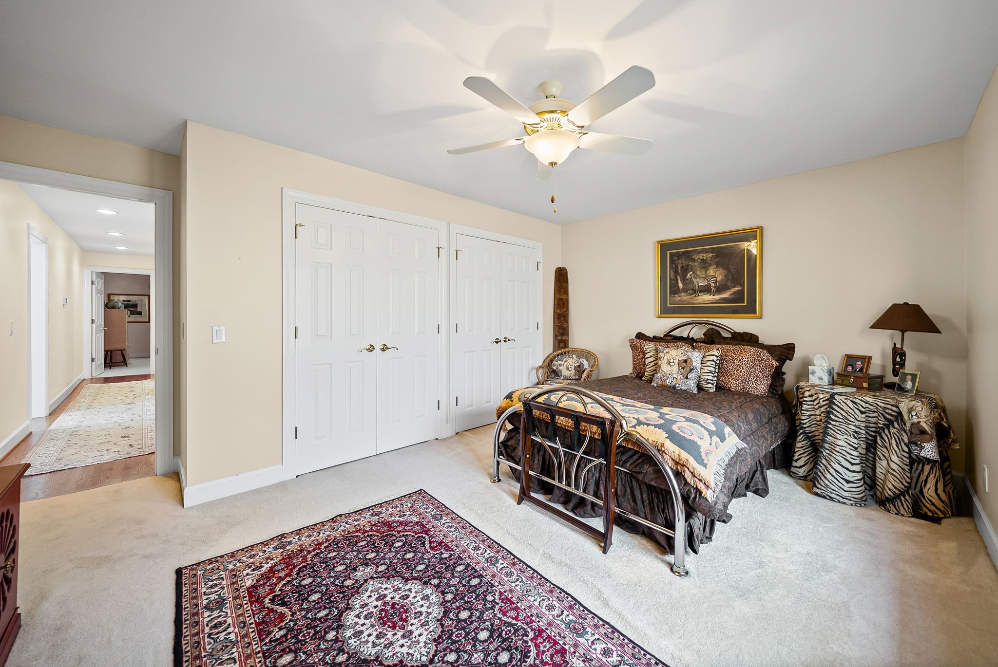 2419 Williams Hollow Road McEwen, TN 37101 - Photo 35 of 85 a spacious bedroom with a bed and a chandelier