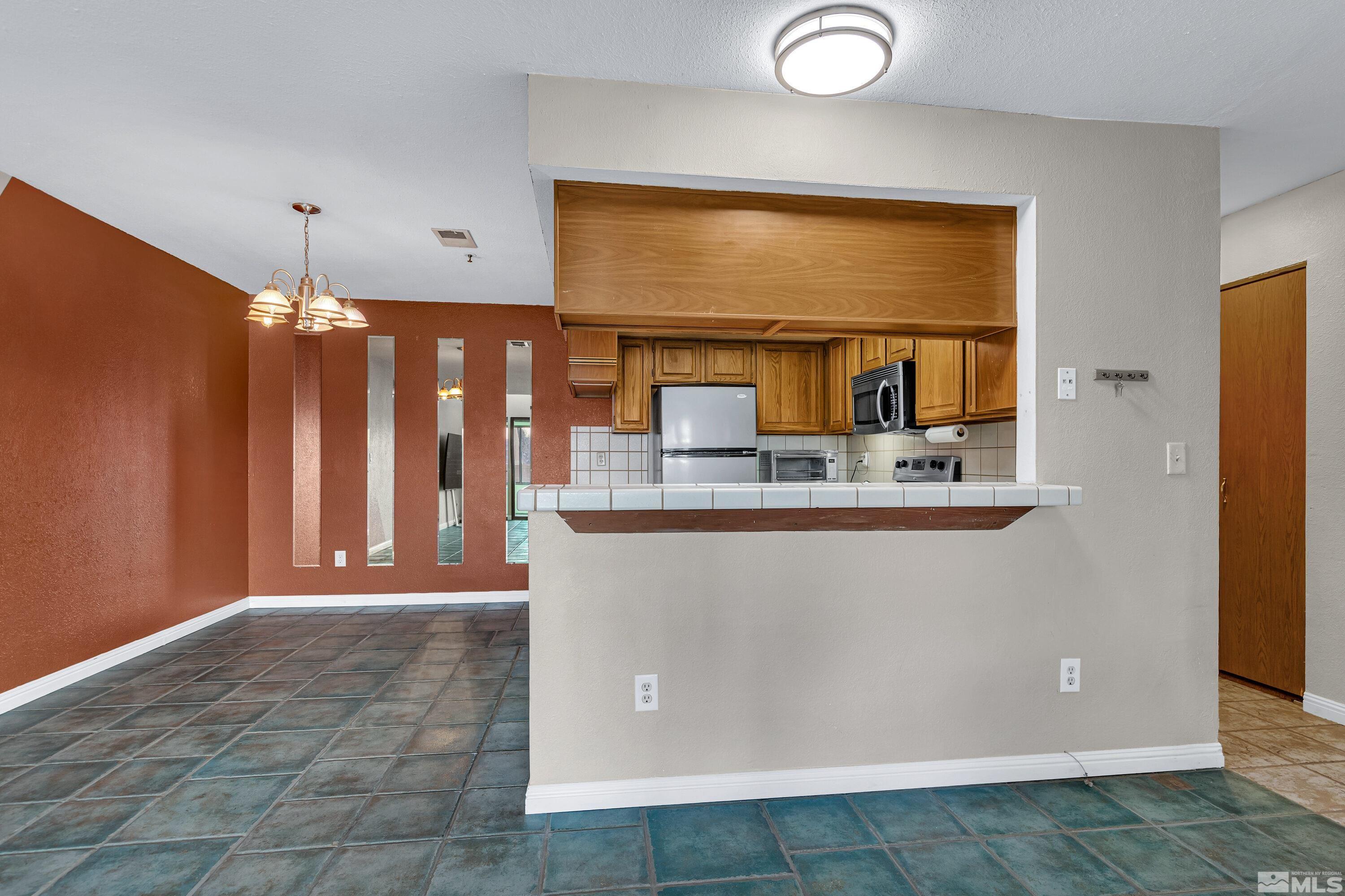 3095 Lakeside Drive, Unit 304 Reno, NV 89509 - Photo 11 of 38 a view of kitchen with stainless steel appliances granite countertop cabinets and a refrigerator