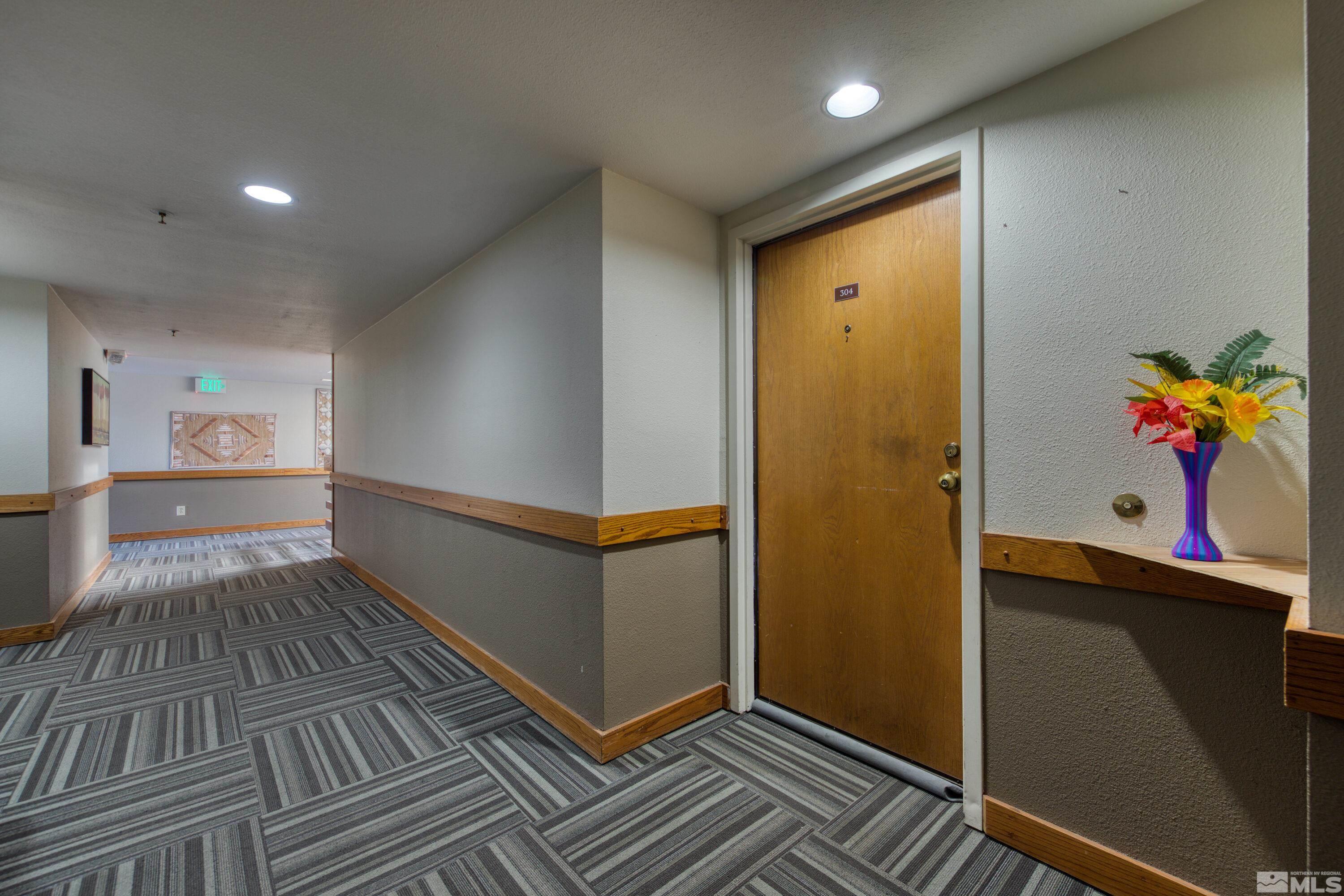 3095 Lakeside Drive, Unit 304 Reno, NV 89509 - Photo 26 of 38 a view of a hallway with wooden floor