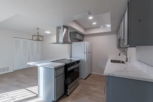 a kitchen with stainless steel appliances granite countertop a sink stove and refrigerator