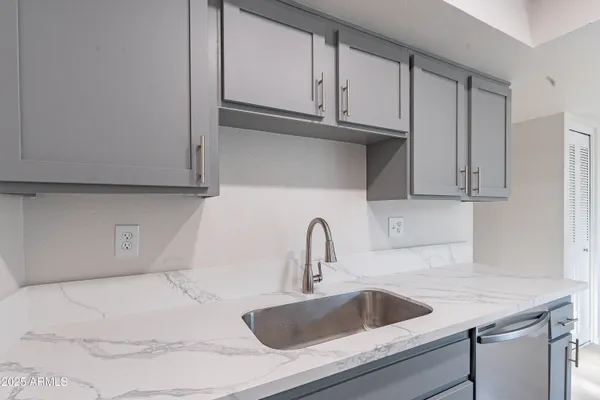 a kitchen with a sink and cabinets