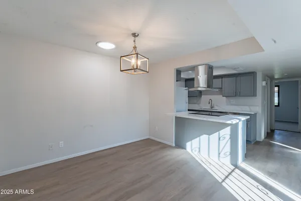 a kitchen with kitchen island a sink appliances and cabinets