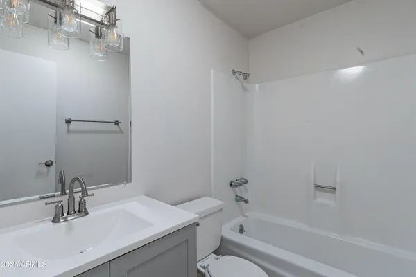a bathroom with a sink toilet vanity and shower