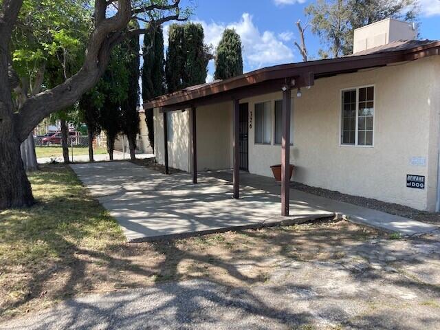 326 East Wilson Street Rialto, CA 92376 - Photo 1 of 19 a view of a house with backyard and tree
