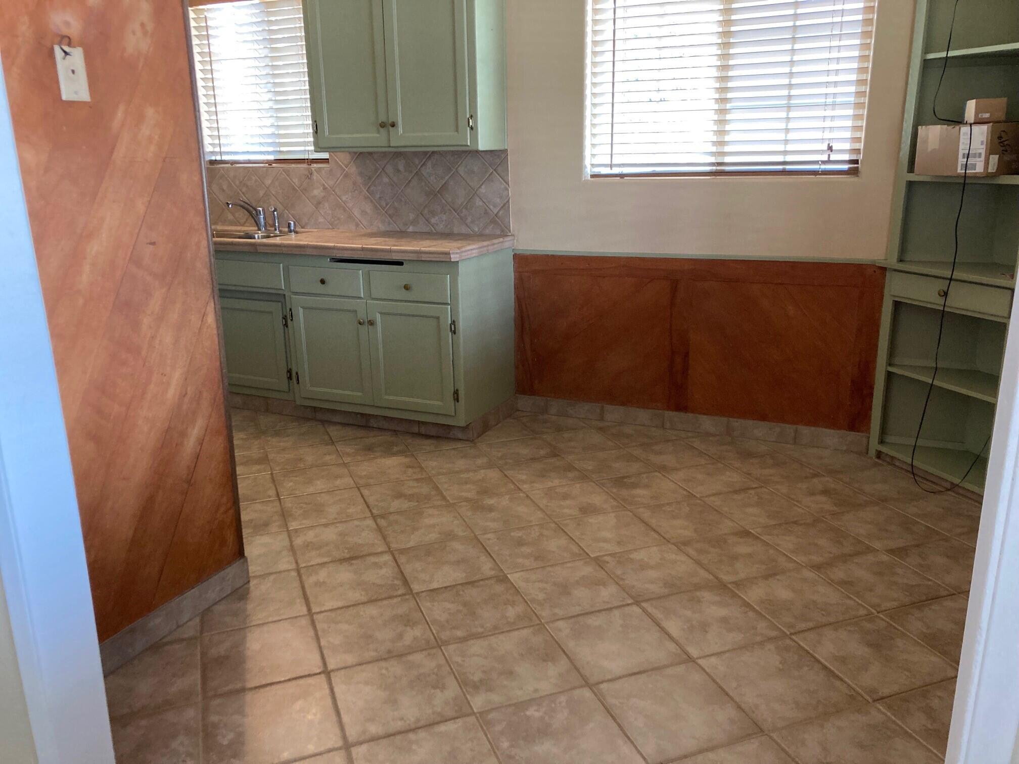 326 East Wilson Street Rialto, CA 92376 - Photo 4 of 19 a kitchen with granite countertop a sink a stove and a window