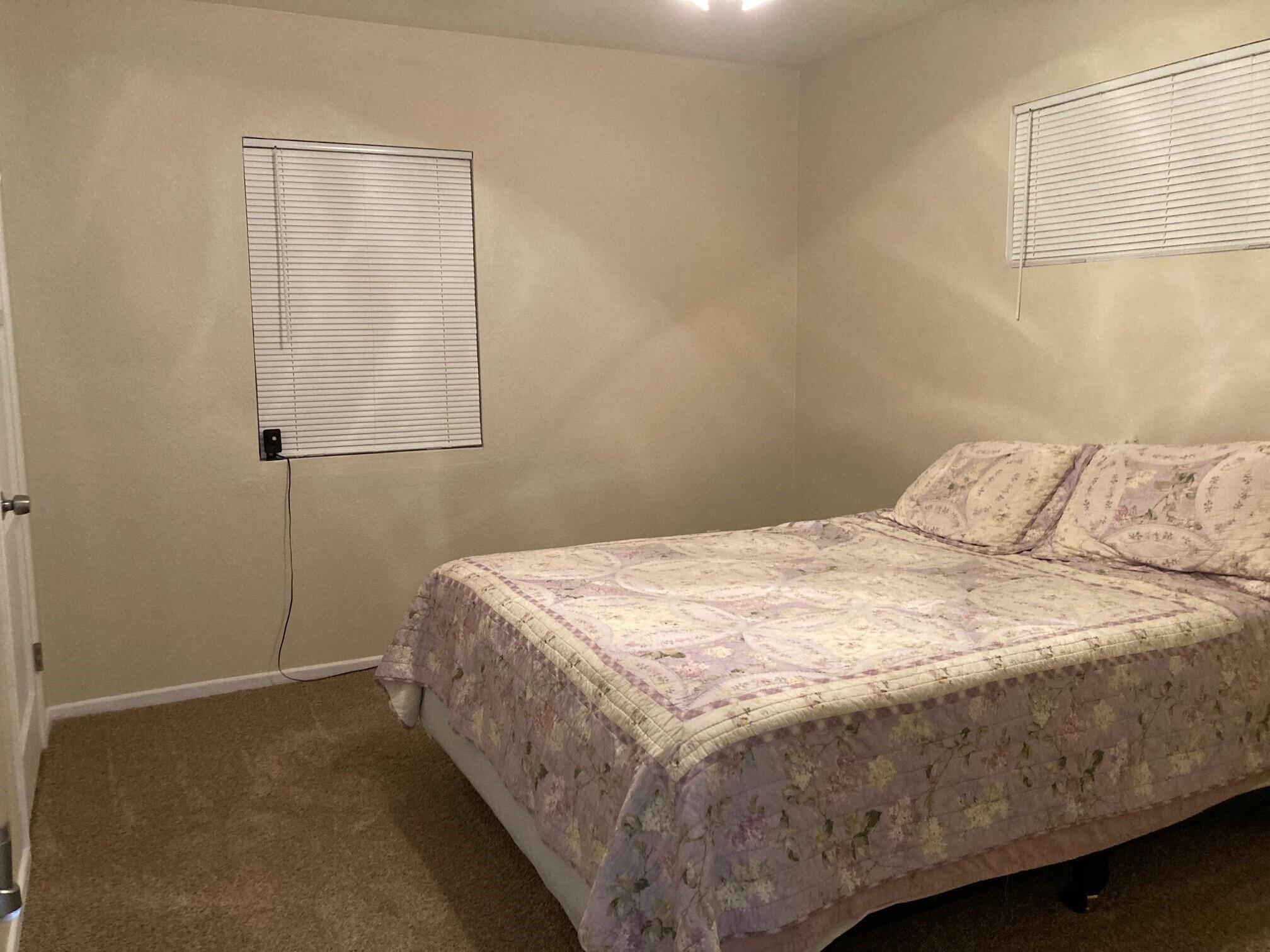 326 East Wilson Street Rialto, CA 92376 - Photo 7 of 19 a bedroom with a bed and a window