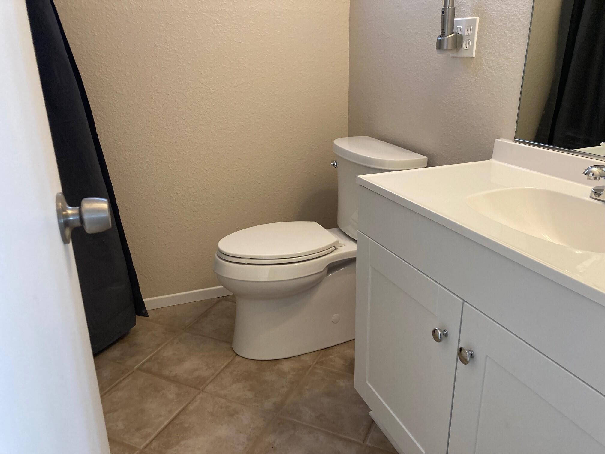 326 East Wilson Street Rialto, CA 92376 - Photo 10 of 19 a white toilet sitting next to a bathroom sink