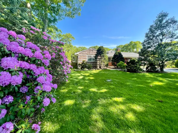 a view of a house with a big yard and garden
