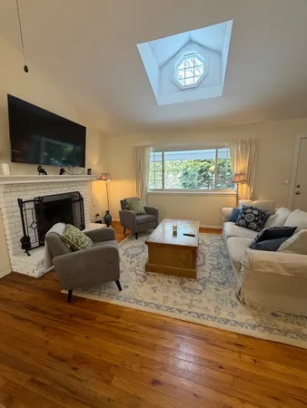 a living room with furniture fireplace and a flat screen tv