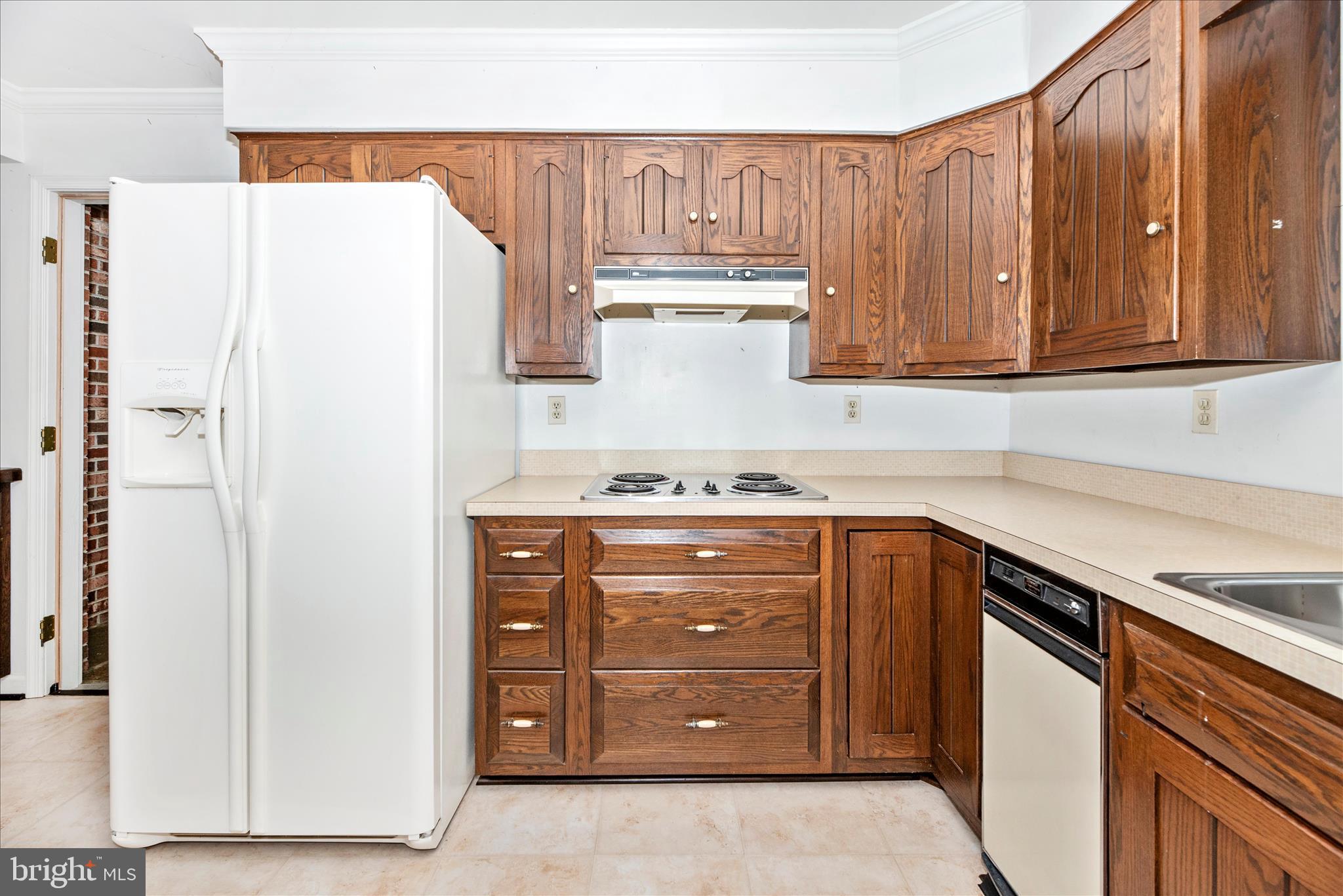 2221 Gold Mine Road Brookeville, MD 20833 - Photo 20 of 60 a kitchen with cabinets and white appliances