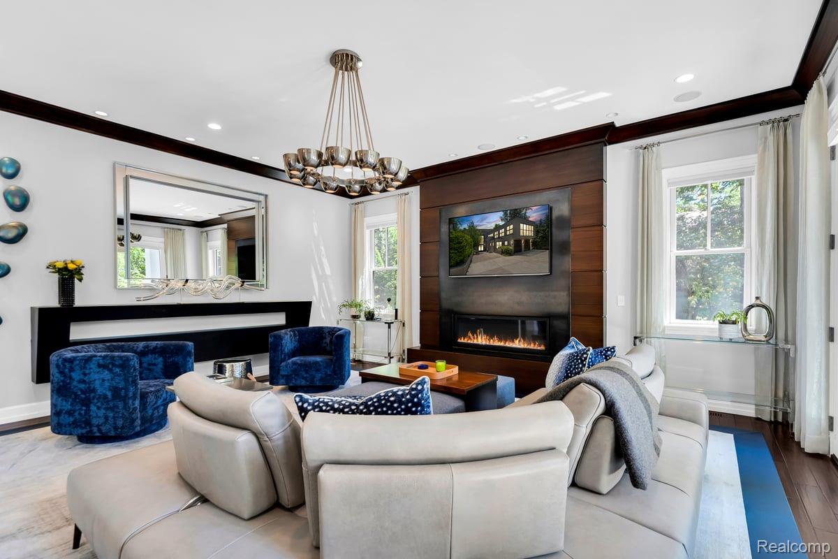 195 Baldwin Road Birmingham, MI 48009 - Photo 19 of 76 Living room featuring a dark wood-paneled fireplace surround with an integrated linear fireplace, a wall-mounted television, and recessed ceiling lighting