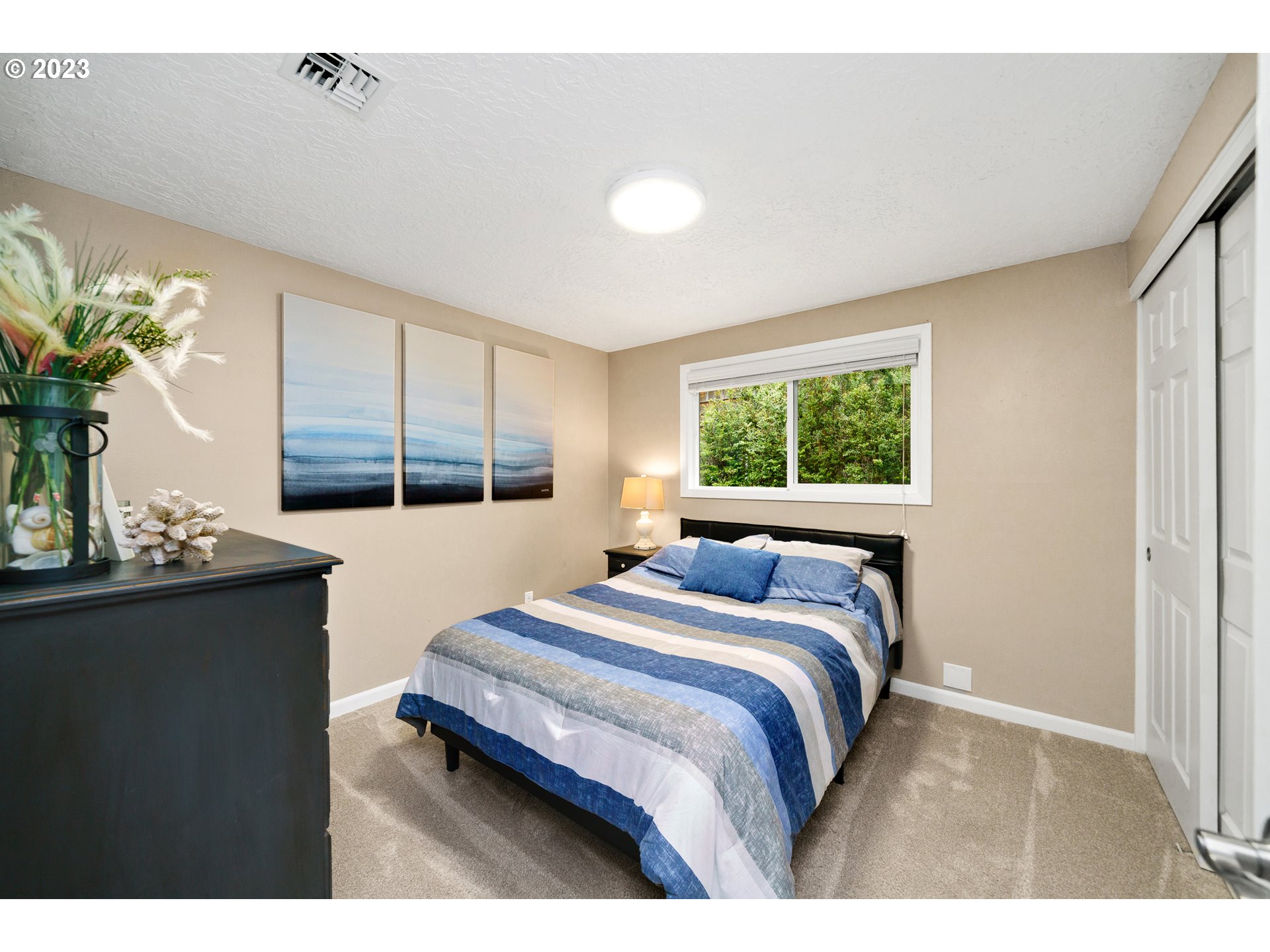 37185 Indian Gap Road Nehalem, OR 97131 - Photo 20 of 33 a bedroom with a large bed and a window