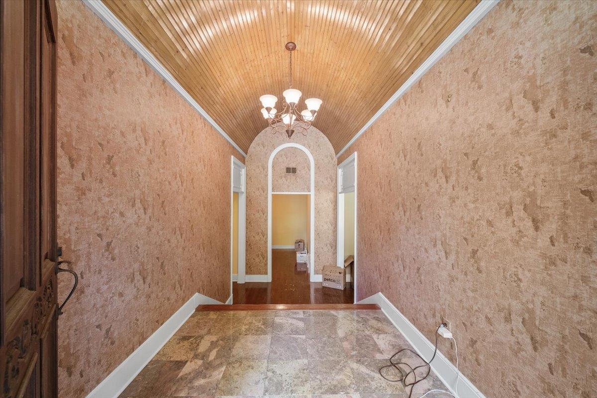 881 South Perkins Road Memphis, TN 38117 - Photo 4 of 33 Unfurnished dining area featuring vaulted ceiling, a chandelier, ornamental molding, and marble finish floors