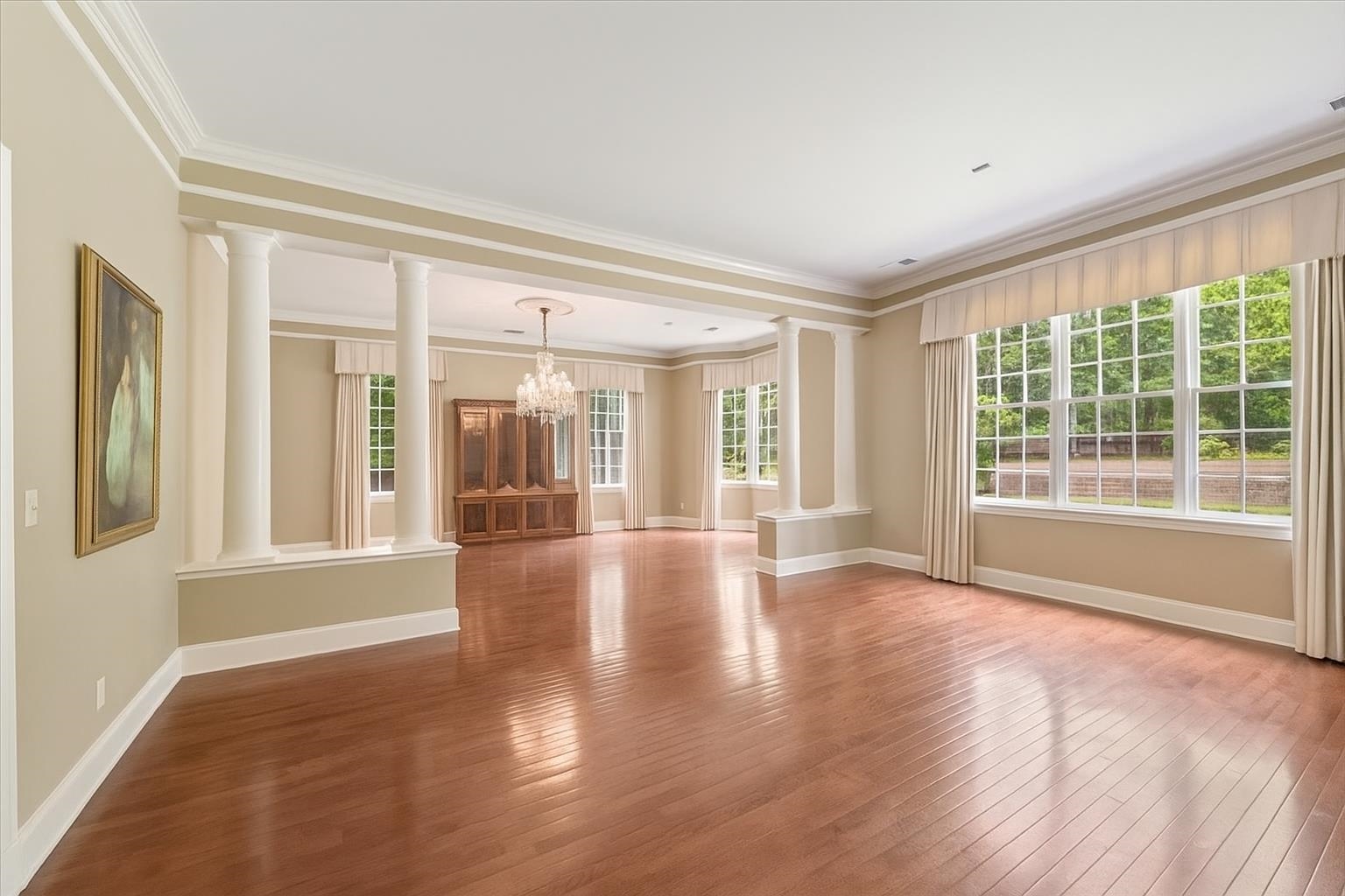 881 South Perkins Road Memphis, TN 38117 - Photo 8 of 33 Spare room with ornate columns, a chandelier, hardwood / wood-style floors, and crown molding
