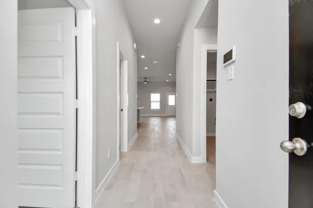 a view of a hallway with wooden shelves
