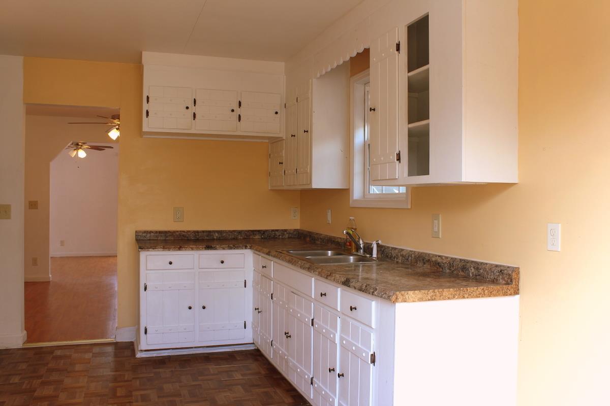 313 Randy Road Madison, TN 37115 - Photo 11 of 22 a kitchen with granite countertop white cabinets and a sink