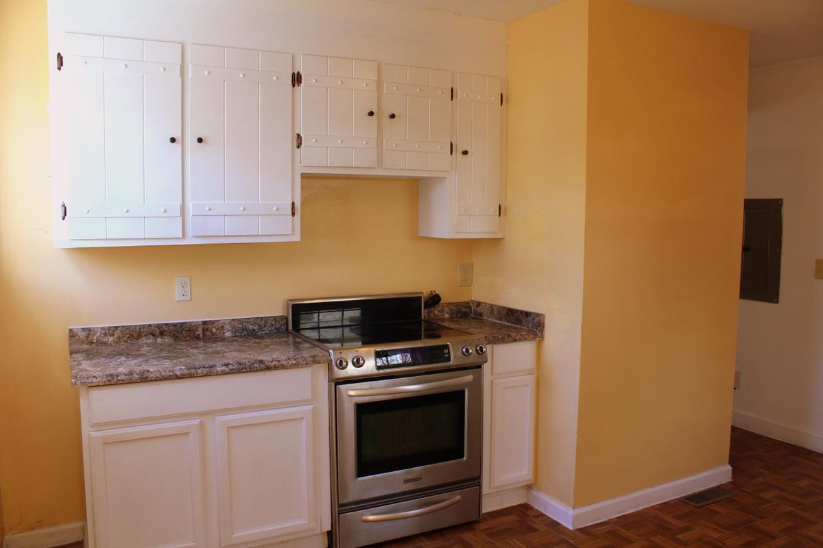 313 Randy Road Madison, TN 37115 - Photo 12 of 22 a kitchen with granite countertop white cabinets and stainless steel appliances