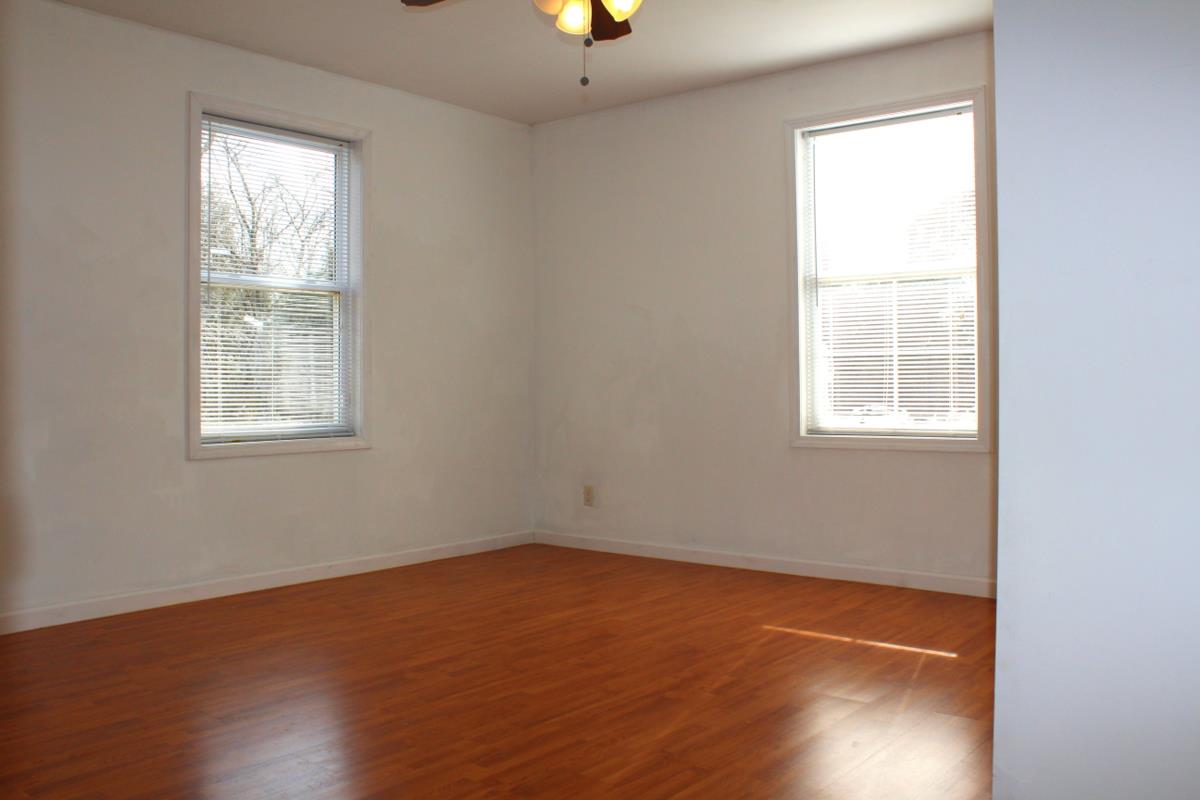 313 Randy Road Madison, TN 37115 - Photo 18 of 22 an empty room with wooden floor and windows