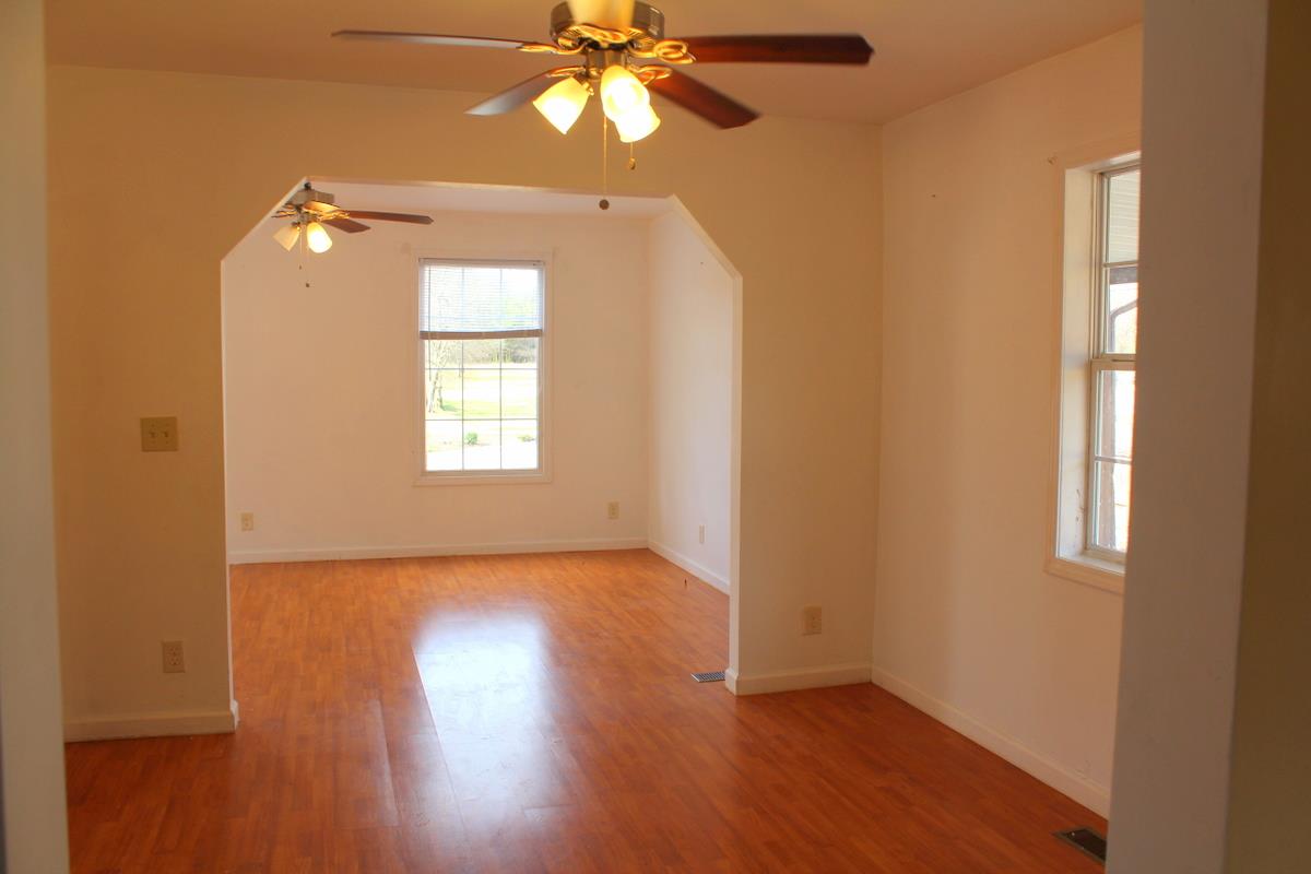 313 Randy Road Madison, TN 37115 - Photo 10 of 22 a view of an empty room with a window and wooden floor