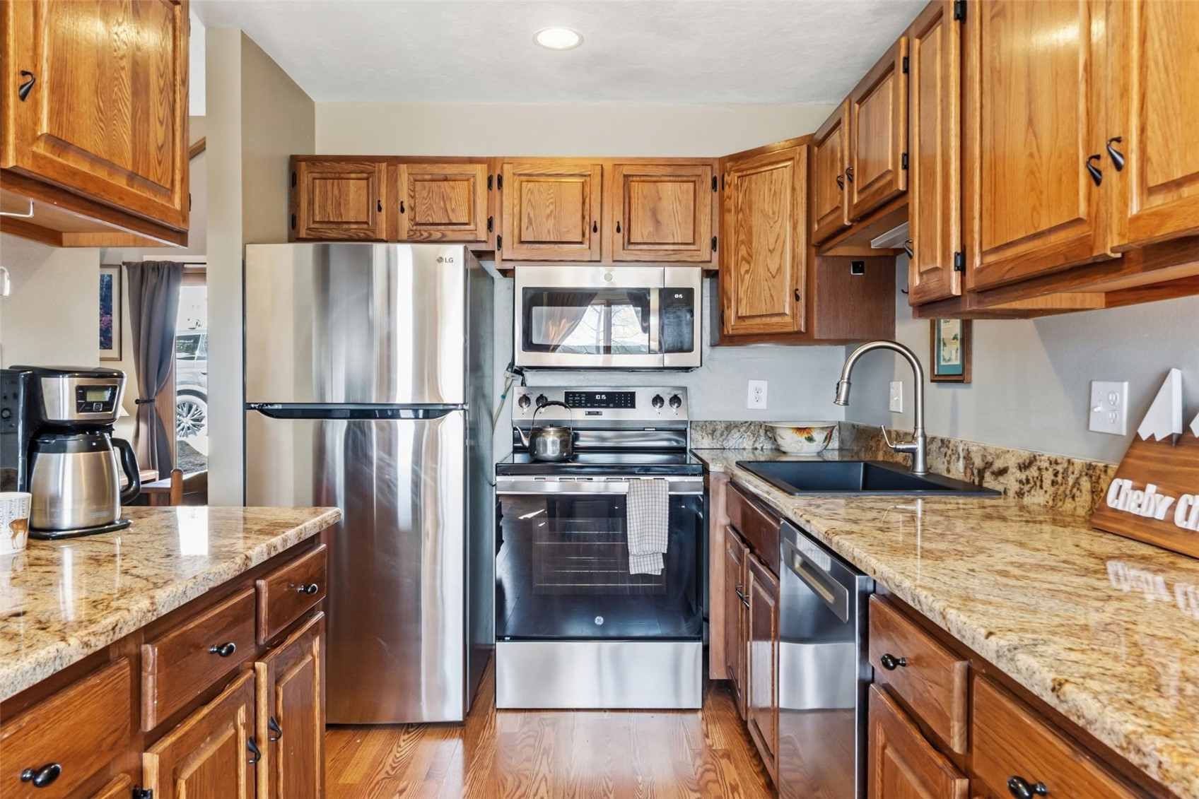 6734 Ryan Gulch Road, Unit 6734 Silverthorne, CO 80498 - Photo 9 of 33 a kitchen with granite countertop a refrigerator stove and sink