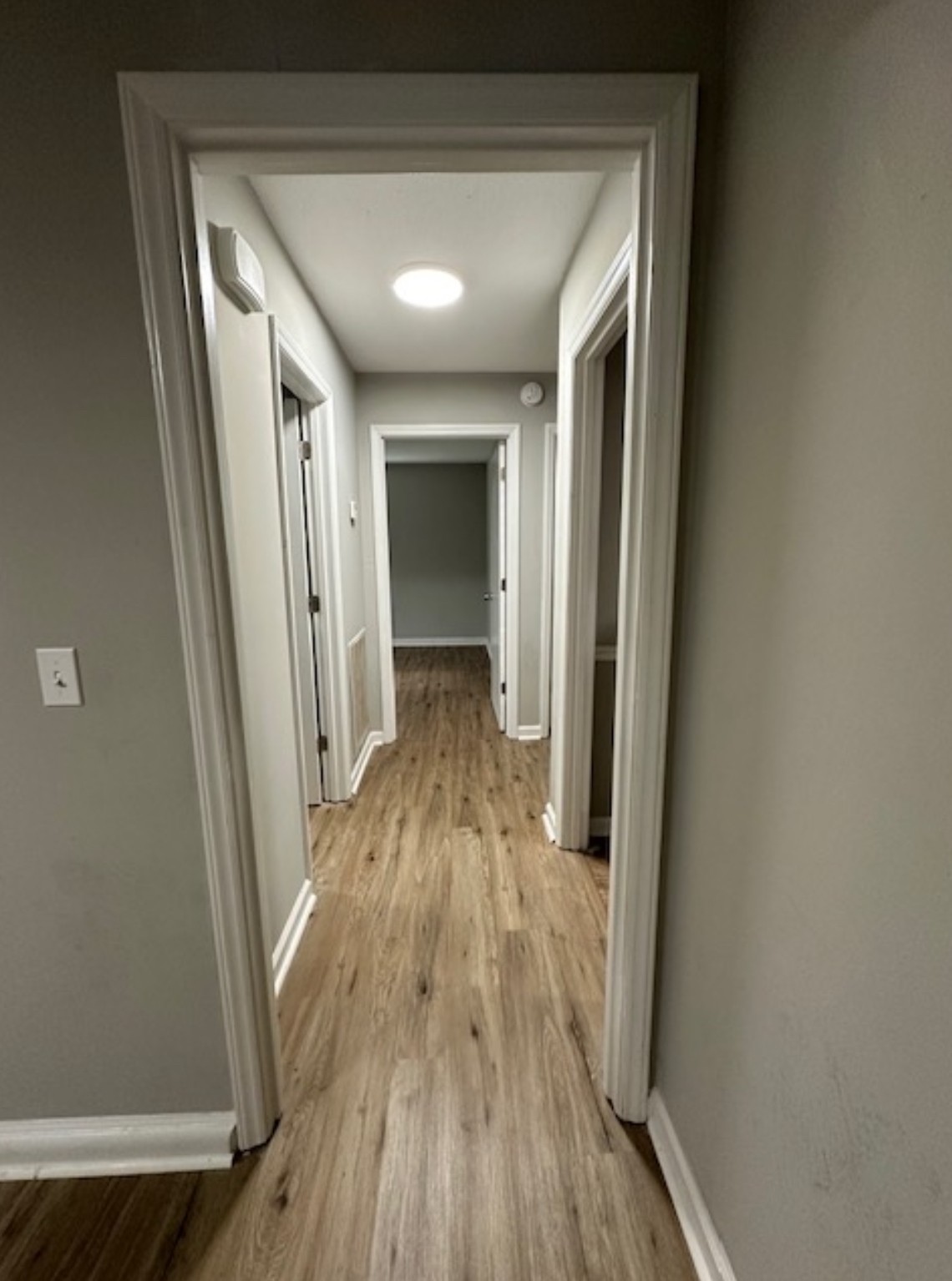 1533 Old Lascassas Road Murfreesboro, TN 37130 - Photo 11 of 13 a view of a hallway with wooden floor and a bathroom