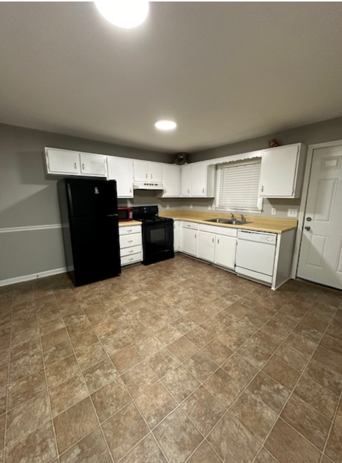 1533 Old Lascassas Road Murfreesboro, TN 37130 - Photo 9 of 13 a kitchen with granite countertop a refrigerator and a stove top oven