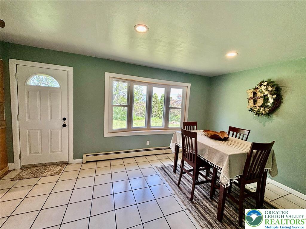 8813 Bluejay Road Kempton, PA 19529 - Photo 11 of 23 This inviting dining area features ample natural light, perfect for gatherings and everyday meals.