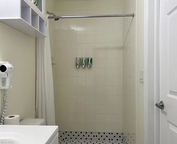 a bathroom with a sink and mirror with toilet
