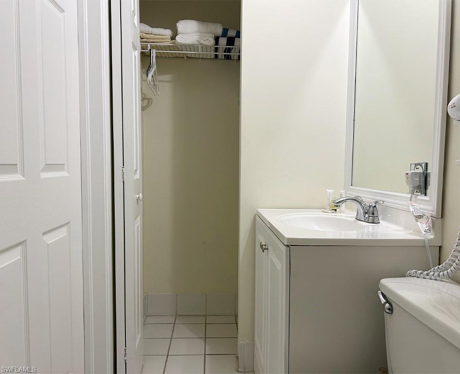 25000 Tamiami Trail East, Unit F179 Naples, FL 34114 - Photo 12 of 13 a bathroom with a sink and mirror with toilet