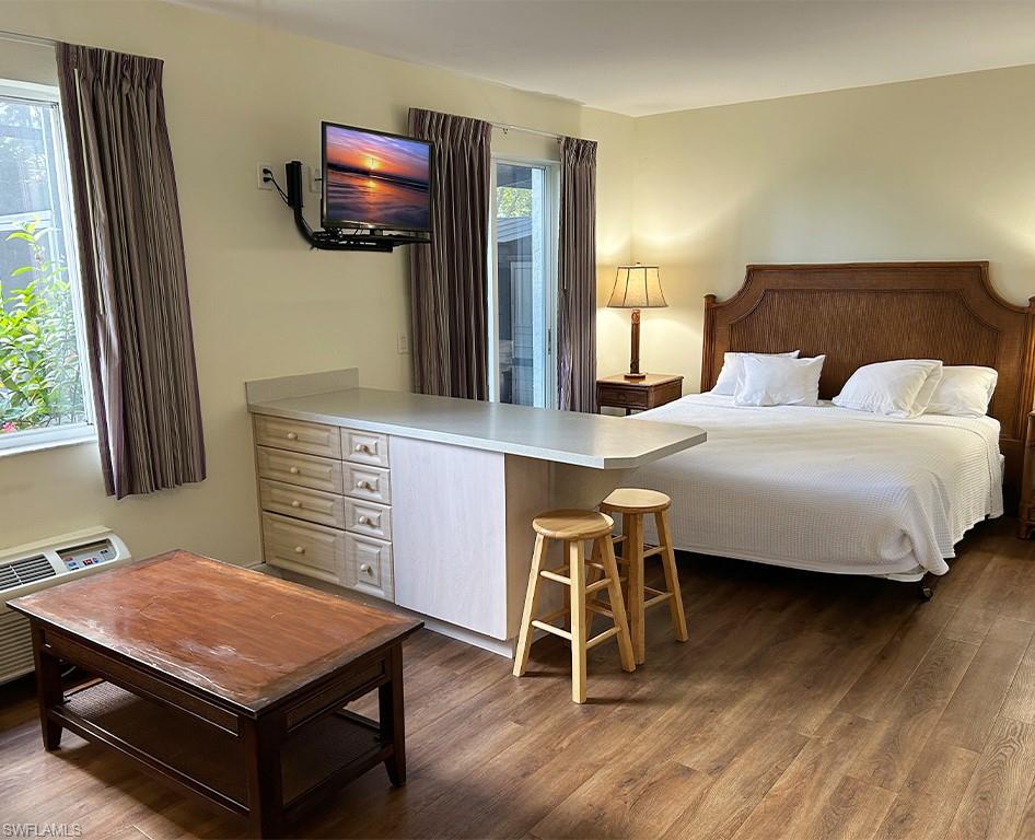 25000 Tamiami Trail East, Unit F179 Naples, FL 34114 - Photo 8 of 13 a bedroom with a bed and a flat screen tv