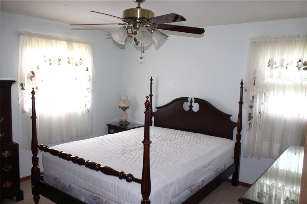 204 Ellsworth Street California, PA 15419 - Photo 14 of 27 a bedroom with a bed and a chandelier