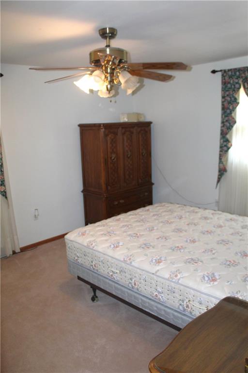 204 Ellsworth Street California, PA 15419 - Photo 16 of 27 a bedroom with a bed and a chandelier