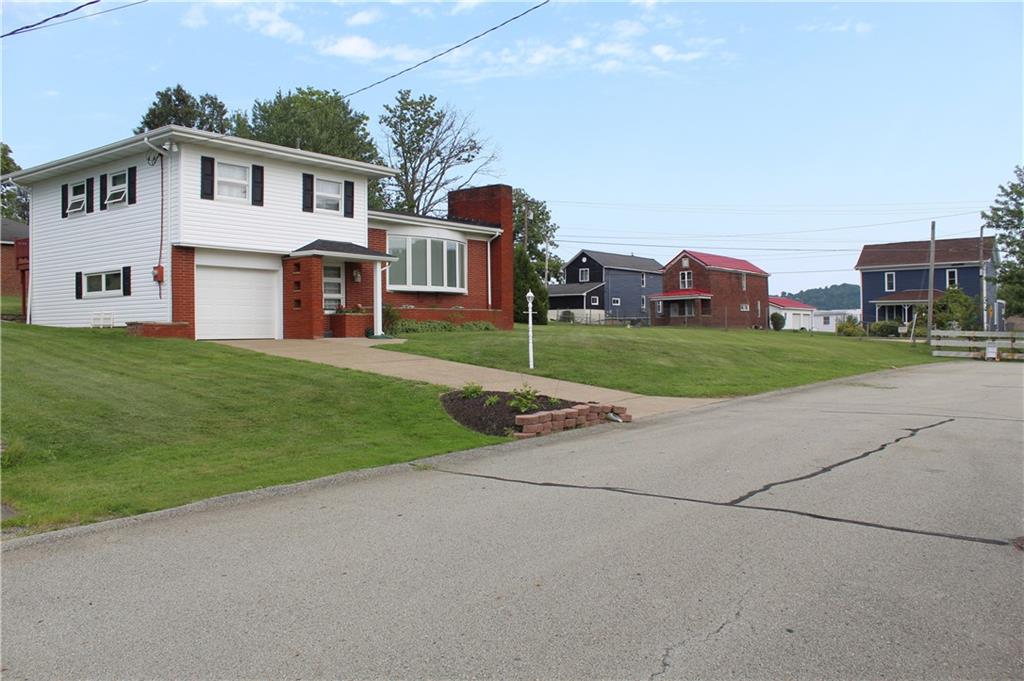 204 Ellsworth Street California, PA 15419 - Photo 2 of 27 a front view of a house with a yard and garage