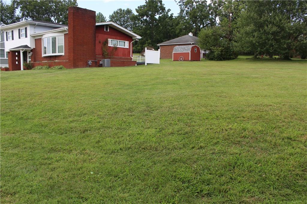 204 Ellsworth Street California, PA 15419 - Photo 27 of 27 a red brick house with lots of trees in front of it