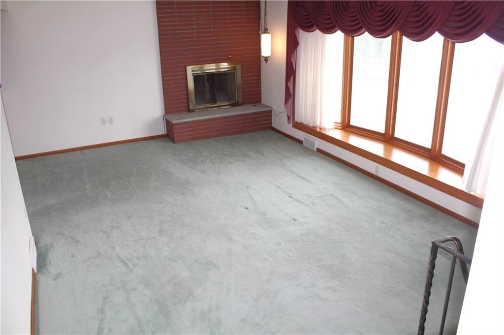 204 Ellsworth Street California, PA 15419 - Photo 5 of 27 a view of an empty room with a fireplace and a window