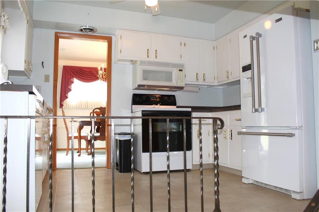204 Ellsworth Street California, PA 15419 - Photo 7 of 27 a kitchen with stainless steel appliances granite countertop a stove a refrigerator and a refrigerator