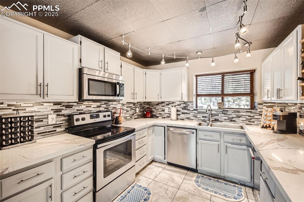 46 Barr Lake Circle Divide, CO 80814 - Photo 11 of 47 a kitchen with white cabinets appliances and a sink
